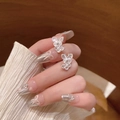 Elegant silver butterfly nail charms with shimmering glitter detail on manicured hands - Elegant Openwork Butterfly Earrings - E6523 Silver