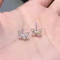 S925 silver butterfly stud earrings featuring colorful stones held in a palm for scale - Colored Zircon Butterfly Earrings - A1120 Silver