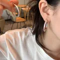 S925 sterling silver hoop earrings with frosted texture finish worn by a model - - Matte Plain Hoop Earrings E6802 White K