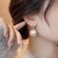 Elegant s925 silver earrings with large white pearls shown on a model with a knit sweater - Large Pearl Earrings - E6957 Gold