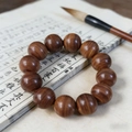 Bulnesia sarmientoi wooden bead bracelet with 13 thick brown beads on calligraphy book - 15mm*15 Beads / Red Sandalwood