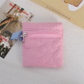 Detail of pink quilted coin purse featuring heart pattern and light blue side strap - Pink