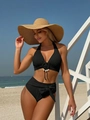Detail van de schelpsluiting en textuurstof van de zwarte bikini met hoge taille - S / Zwart