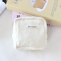 Detail shot of the cream corduroy texture and zip closure on the square storage bag - Creamy White