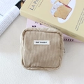 Detailed macro of khaki corduroy makeup bag with MAY RABBIT label and smooth zipper - Apricot