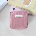Close-up of pink corduroy storage bag with zipper and May Rabbit fabric label detail - Nude Pink