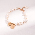 Détail du bracelet en perles d'eau douce avec breloque cœur et gravure Good Luck - Bracelet de perles