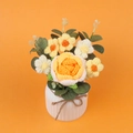 Detail of handmade crochet orange rose and small wild flowers in a white ceramic pot - Gradient Yellow Rose
