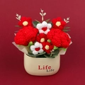 Handmade crochet rose potted plant ornament with red and white flowers on red background - Red
