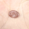 Macro detail of polished pink strawberry crystal pig nose button with natural textures - 10*14*4mm / Strawberry Quartz