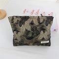 Close-up of vintage black and gold jacquard makeup bag with butterfly motifs and May Rabbit label - Gilded Butterfly