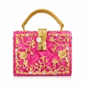 Macro view of bright pink acrylic clutch featuring intricate gold floral carving and crystals - Rose Red