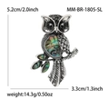 Elegante broche de búho con alas de concha de abalón natural y ojos de piedras negras - Plateado