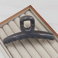 Macro detail of large 13cm dark gray translucent shark hair claw clip in a jewelry box - 13CM Hanger Style / Gray