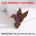 Vintage gold hummingbird brooch with purple and deep red rhinestones and detailed carving - Pink Rhinestone Gold Base