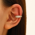 Detail of gold-plated ear cuff with pavé-set white zircons shown on a model's ear - KC Gold Pave Snake (DZ-961)