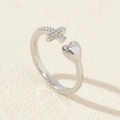 Detail of silver open ring featuring a smooth heart and zircon-encrusted cross - Style 26