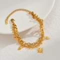 Double-layered gold stainless steel bracelet featuring an eight-pointed star and leaf pendant - Gold