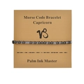 Detail of Capricorn morse code bracelet with black obsidian beads on display card - Capricorn