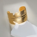 Detailed view of 18K gold plated wide cuff bracelet featuring textured feather engraving - Wide Feather Bracelet (M-B1081)