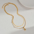 Elegante collar de doble capa de acero de titanio dorado con colgante de gota pulido - Collar de Gota de Agua