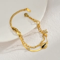 Detail of layered gold bracelet featuring ladybug and pavé star charms on snake chain - Ladybug Star Layered Style