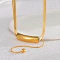 Minimalist gold snake chain necklace with curved bar pendant on a stone tray - Curved Tube Style (Style 1)