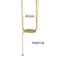 Goldene Schlangenkette mit gebogenem Rohr-Anhänger und kleiner Metallkugel auf weißem Hintergrund - Zylindrischer Gebogener Rohr-Stil