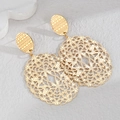 Detail of gold hollow floral pattern earrings with intricate filigree on stone background - Mandala Oval Style (A款)