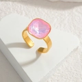 Detail of a large square-cut pink gemstone on a gold adjustable ring band - Pink