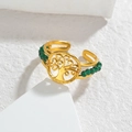 Gros plan d'une bague ajustable dorée avec motif arbre de vie et perles vertes - Or - Perles Vertes