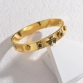Polished 18K gold plated bangle with embossed clover patterns and black stone inlays - Black Zirconia