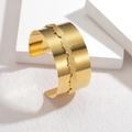 Polished gold wide cuff bracelet with textured chain center on a minimalist white display - Golden Wide Cuff Style
