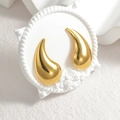 Minimalist gold teardrop stud earrings with a polished finish on a stone pedestal - Gold