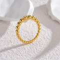 Modern minimalist gold beaded bubble ring displayed on textured white stone surface - One Size / Gold