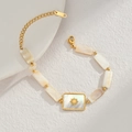 Gold beaded bracelet with shell tiles and a sunburst pendant on minimalist background - Shell Beaded Bracelet