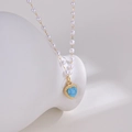 Elegant gold titanium steel necklace featuring white pearls and a blue marble heart pendant - Pearl Necklace