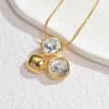 Golden square zircon pendant necklace featuring a snake chain on a white stone display - Triple Square Pendant Necklace Style (S132-N)
