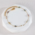 Elegant gold beaded bracelet with colorful stones displayed on an octagonal stand - S135-B Bracelet