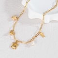 Gouden ketting met schildpad- en visgraathangers en een glanzende witte parel - Schildpad Visgraat Parel Zeester Stijl (N2226-C)
