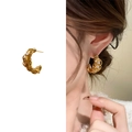18k gold plated spiral stud earring with cubic zirconia stones shown on ear model - Gold