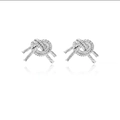 Detailed close-up of 14K knot-shaped earrings with fine silver finish and rope texture - 14k / Silver