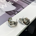 Detailed view of layered silver-toned twisted ribbon earrings with a polished mirror finish - 925 Silver Needle / Silver