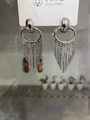Macro shot of silver tassel earrings with multiple fine metal chains on a display card - 24K Gold Plated / Silver
