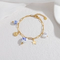 Elegant gold chain bracelet with ocean-themed ceramic beads and mixed star pendants - Gold Sunflower Style