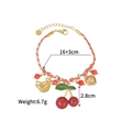 Détail d'un bracelet tissé avec des breloques de fruits colorés et un fermoir ajustable - Thème Fruit (OLBB1215-A)