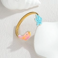 Triple layer gold plated turtle and fish cuff bangle on a white marble stone surface - Turtle