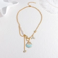 Minimalist stainless steel pearl necklace with shell and fish tail charms on white plate - Ocean Theme Style (Gold)