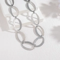 Minimalist silver oval link necklace with hammered metal texture on geometric white stand - Silver (SFLN2283-01)