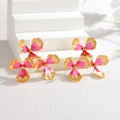 Vintage gold-trimmed pink enamel flower earrings on white stone display stand - Yellow and Pink Gradient
